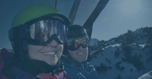 Smiling couple of ski lift